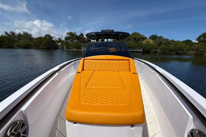 Slide: The Image of Luxury VIRTUE YACHTS V10 TOP 2026 with vibrant orange seating on a serene waterway. - 18