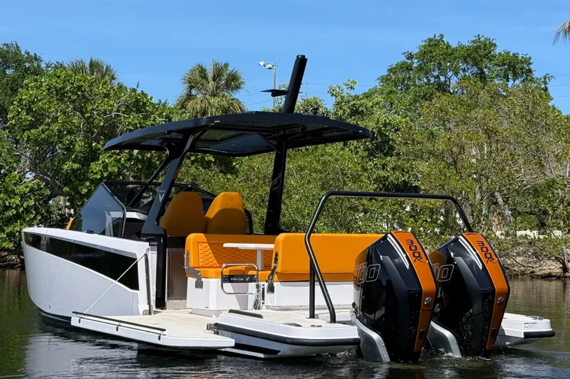 Slide: The Image of 2026 VIRTUE YACHTS V10 TOP with dual engines, sleek design, and vibrant seating. - 2