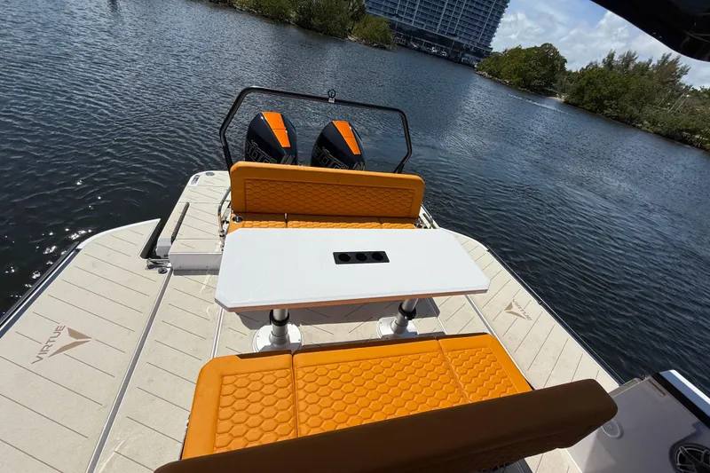 Slide: The Image of Luxury VIRTUE YACHTS V10 TOP 2026 with orange seating and dual engines on a serene lake. - 7