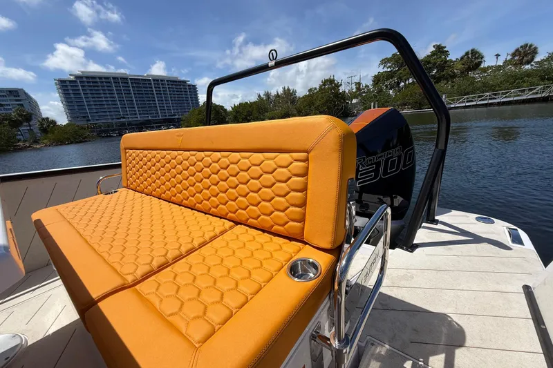 Slide: The Image of Orange seating on 2026 VIRTUE YACHTS V10 TOP, with water and buildings in background. - 9