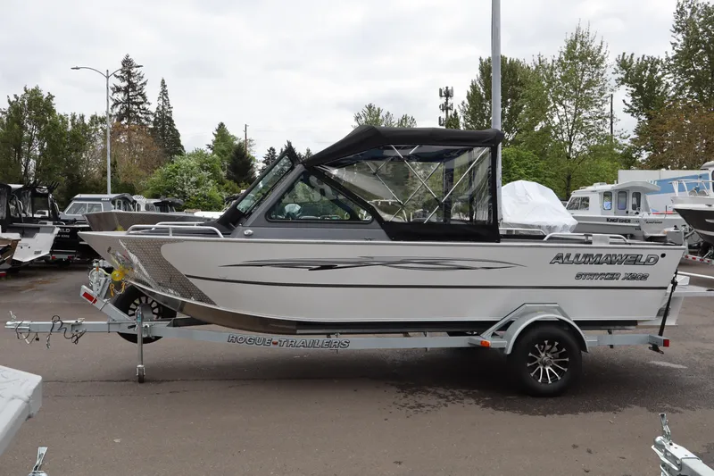 The Image of 2026 Alumaweld Stryker X202 boat on Rogue trailer, parked outdoors. - 1