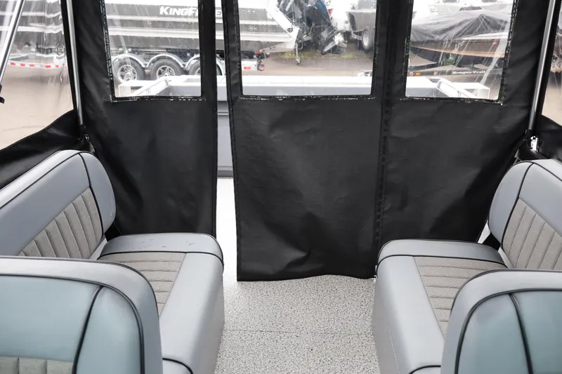 Slide: The Image of Interior view of 2026 Alumaweld Stryker X202 boat with gray seating and black curtains. - 16