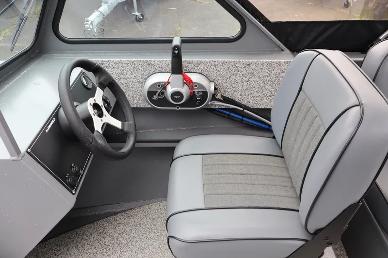 Slide: The Image of Interior of 2026 Alumaweld Talon 18 boat, featuring steering wheel and control panel. - 12