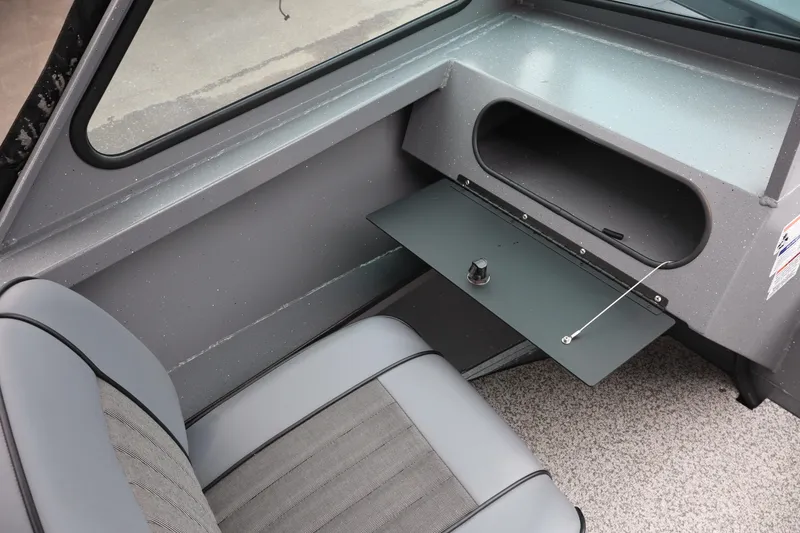 Slide: The Image of 2026 Alumaweld Talon 18 interior with gray seating and storage compartment. - 14