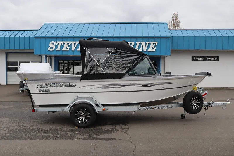 Slide: The Image of 2026 Alumaweld Talon 18 boat on trailer, parked outside marine dealership. - 3