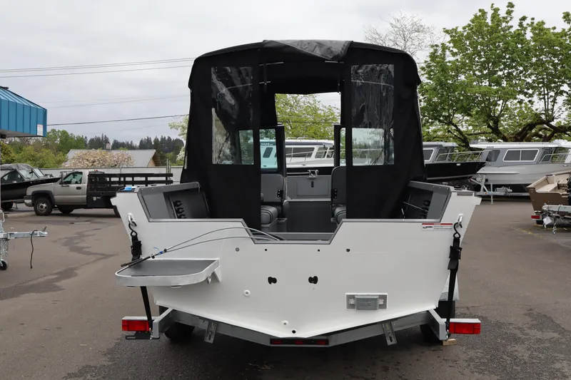 Slide: The Image of 2026 Alumaweld Talon 18 boat with canopy, parked outdoors on a trailer. - 5