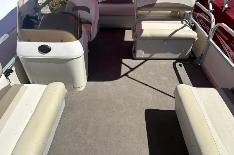 Slide: The Image of 2011 Sun Tracker Bass Buggy 18 Classic Series interior with beige seating and helm. - 6