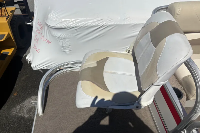 Slide: The Image of 2011 Sun Tracker Bass Buggy 18 Classic Series boat seat with white and beige upholstery. - 7