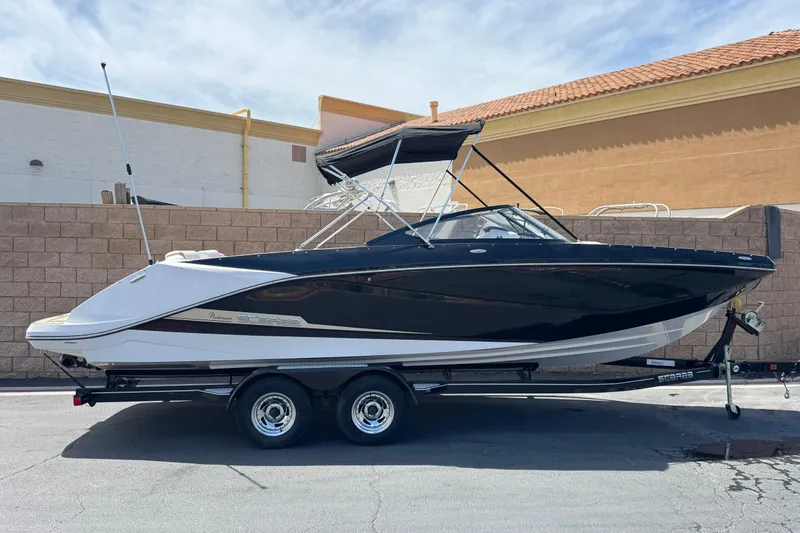 The Image of 2017 Scarab 255 H.O. Platinum boat on trailer, parked outdoors. - 0