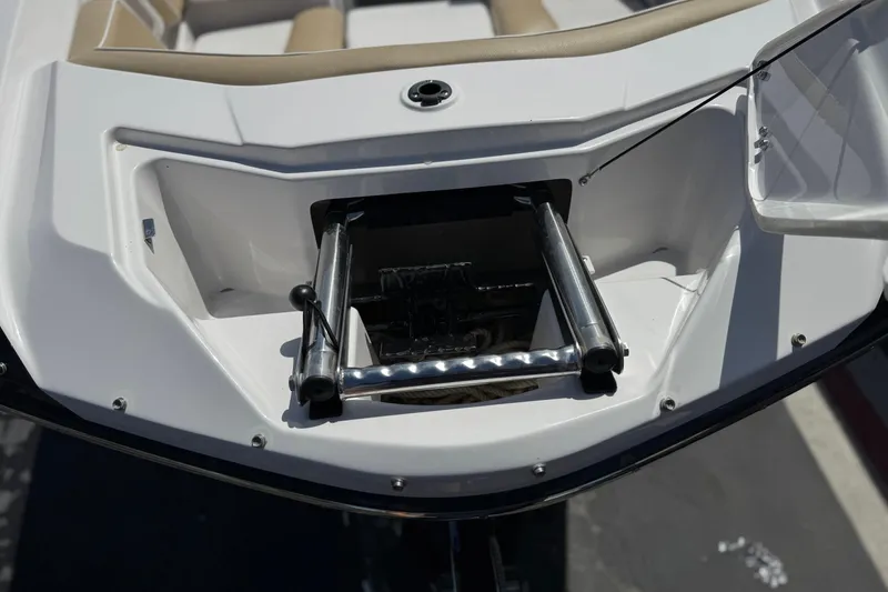 Slide: The Image of 2017 Scarab 255 H.O. Platinum boat with retractable ladder in open compartment. - 12