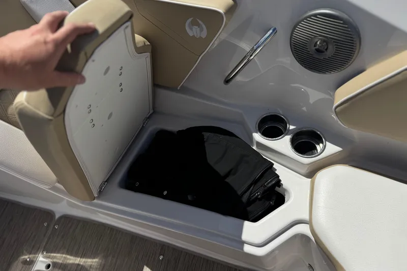 Slide: The Image of 2017 Scarab 255 H.O. Platinum boat interior with storage compartment and cup holders. - 17
