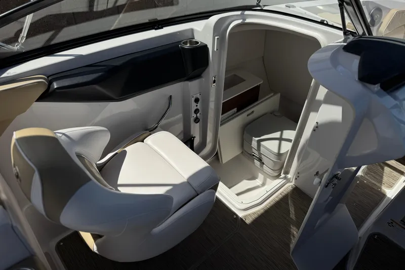 Slide: The Image of 2017 Scarab 255 H.O. Platinum boat interior with seating and compact restroom. - 28