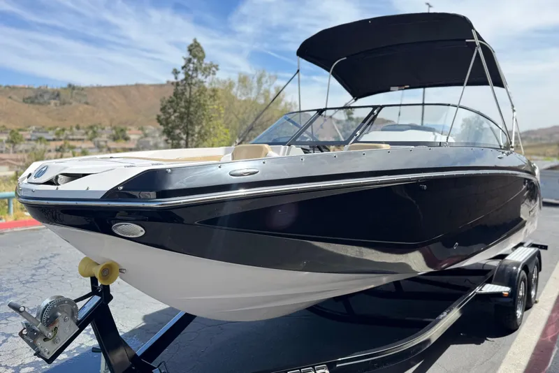 Slide: The Image of 2017 Scarab 255 H.O. Platinum boat on trailer, black and white design, sunny day. - 3