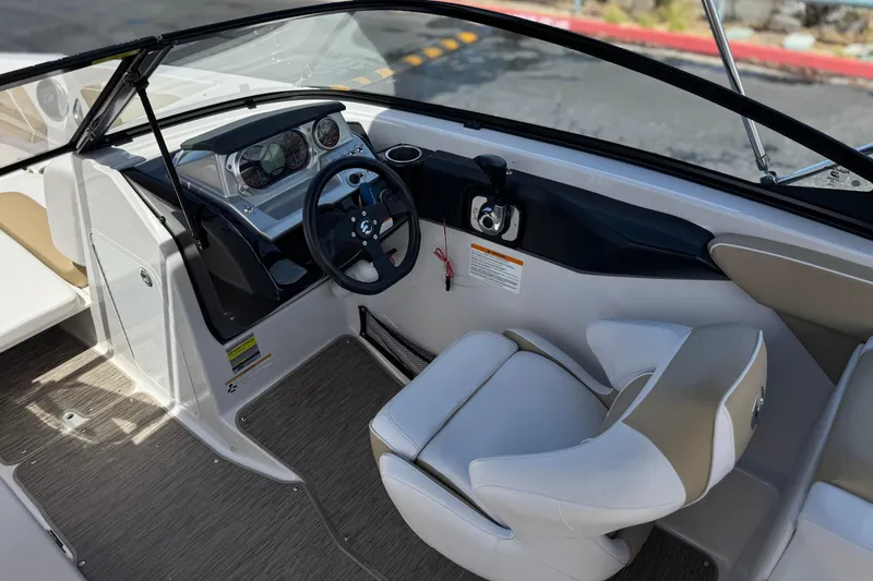 Slide: The Image of Interior view of 2017 Scarab 255 H.O. Platinum boat cockpit with steering wheel and seating. - 31