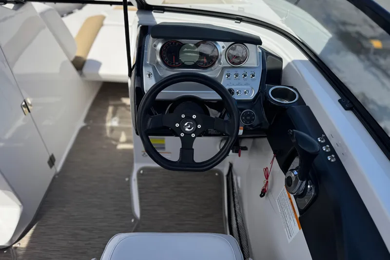 Slide: The Image of 2017 Scarab 255 H.O. Platinum boat cockpit with steering wheel and control panel. - 32