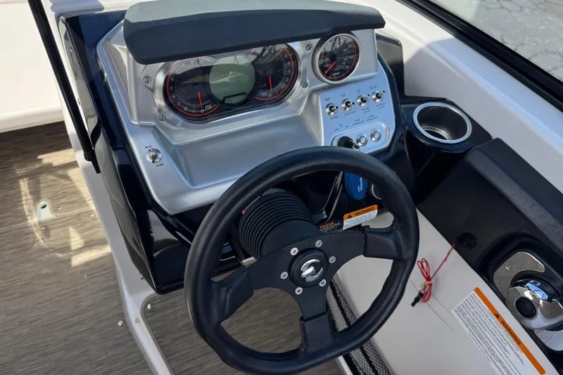 Slide: The Image of Dashboard of a 2017 Scarab 255 H.O. Platinum boat with steering wheel and gauges. - 33