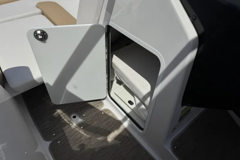Slide: The Image of Open storage compartment on 2017 Scarab 255 H.O. Platinum boat, featuring sleek interior design. - 35