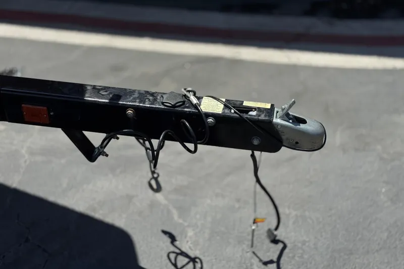 Slide: The Image of Trailer hitch of a 2017 Scarab 255 H.O. Platinum boat on pavement. - 36