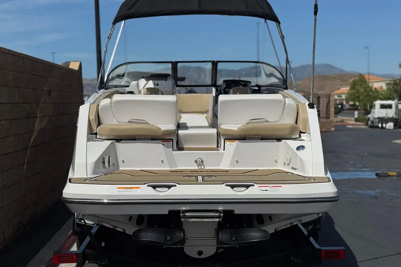 Slide: The Image of 2017 Scarab 255 H.O. Platinum boat, rear view, parked outdoors. - 4