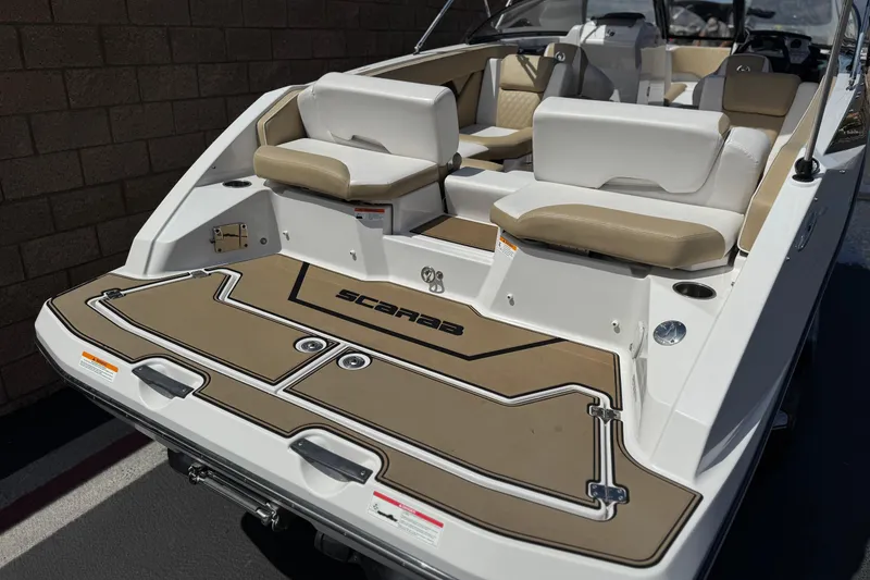 Slide: The Image of 2017 Scarab 255 H.O. Platinum boat with tan and white seating, rear view. - 6
