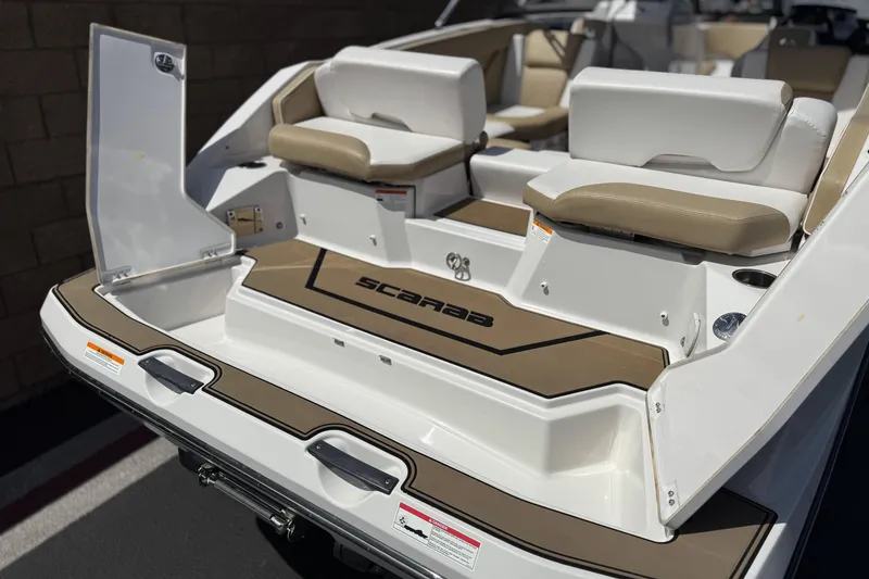 Slide: The Image of 2017 Scarab 255 H.O. Platinum boat interior with seating and storage compartments. - 7