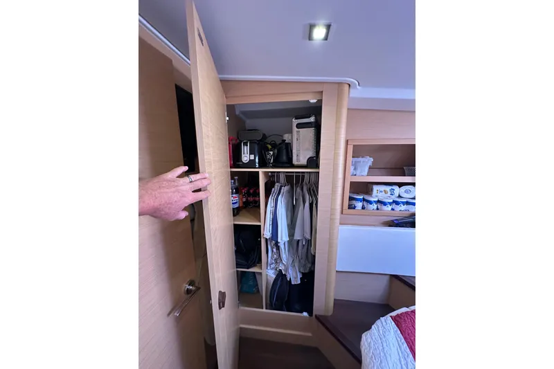 Slide: The Image of Closet interior on 2011 Beneteau Monte Carlo 47 Fly yacht, featuring organized storage. - 38
