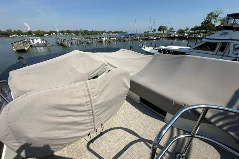 Slide: The Image of 2011 Beneteau Monte Carlo 47 Fly yacht with covered seating, docked at a marina. - 51