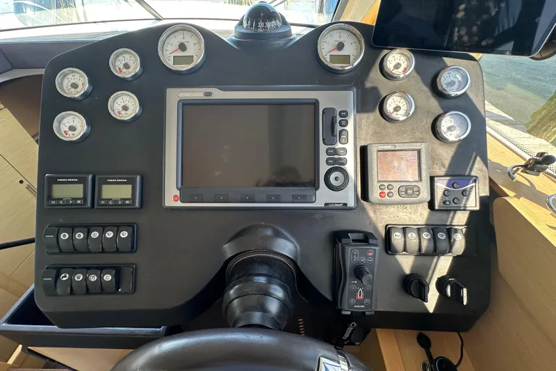 Slide: The Image of Control panel of a 2011 Beneteau Monte Carlo 47 Fly yacht with gauges and navigation equipment. - 23