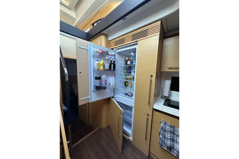 Slide: The Image of Modern kitchen interior of 2011 Beneteau Monte Carlo 47 Fly yacht with open fridge. - 33