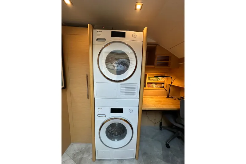 Slide: The Image of Stacked Miele washer and dryer in a modern laundry room on a 2011 Beneteau Monte Carlo 47 Fly. - 28