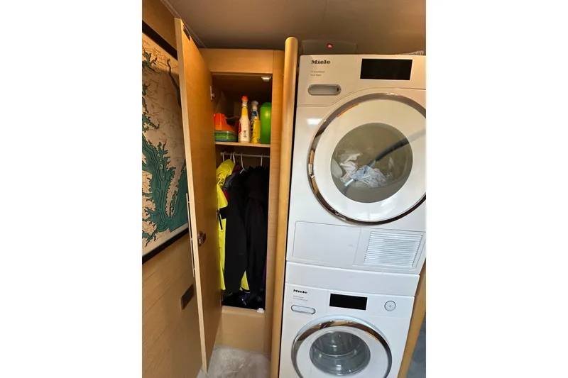 Slide: The Image of Laundry area on 2011 Beneteau Monte Carlo 47 Fly with Miele appliances and storage. - 29