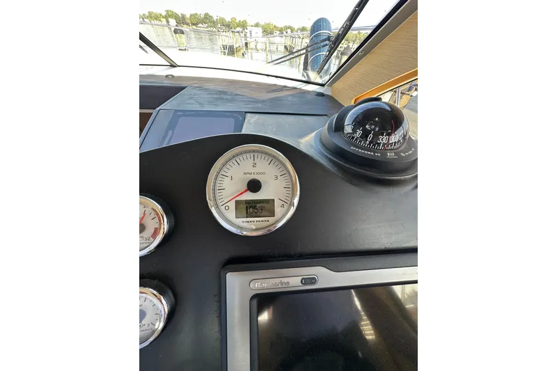Slide: The Image of Dashboard of a 2011 Beneteau Monte Carlo 47 Fly with compass and gauges. - 25