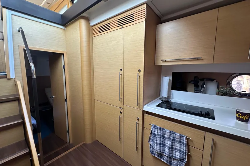 Slide: The Image of Modern kitchen interior of 2011 Beneteau Monte Carlo 47 Fly yacht, featuring sleek cabinetry and appliances. - 32