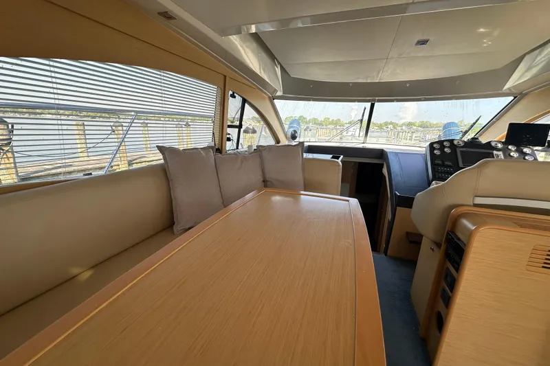 Slide: The Image of Interior of 2011 Beneteau Monte Carlo 47 Fly yacht, featuring elegant seating and helm. - 16