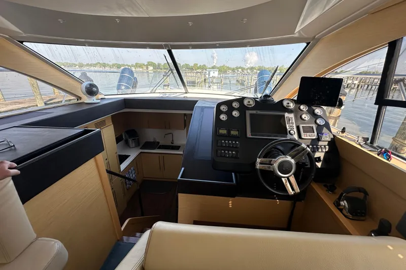 Slide: The Image of Interior helm of 2011 Beneteau Monte Carlo 47 Fly yacht, featuring modern controls and panoramic view. - 21