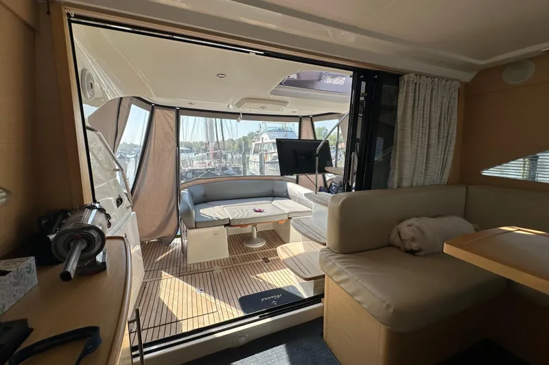 Slide: The Image of Interior of 2011 Beneteau Monte Carlo 47 Fly yacht with cozy seating and a small dog. - 19