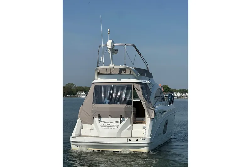 Slide: The Image of 2011 Beneteau Monte Carlo 47 Fly yacht on calm water, rear view. - 2