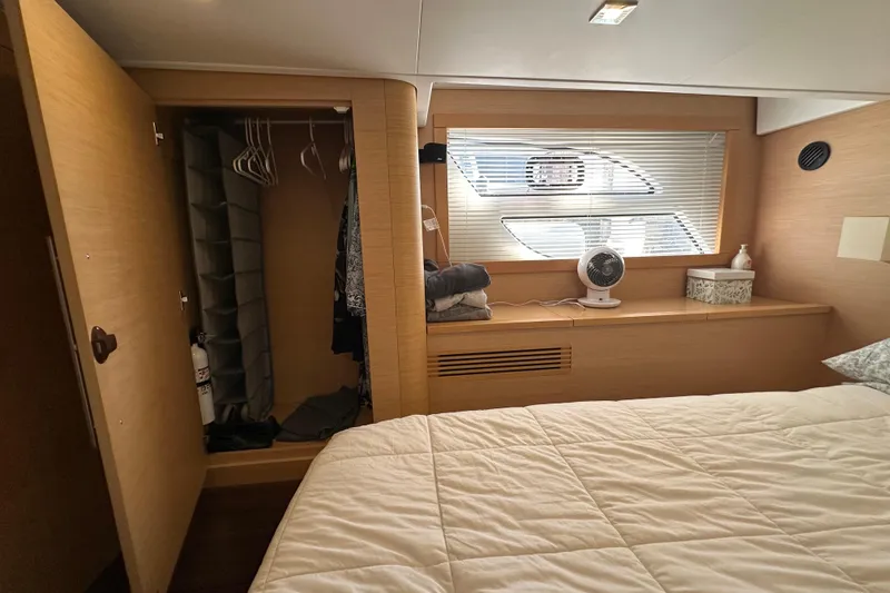 Slide: The Image of Interior cabin of 2011 Beneteau Monte Carlo 47 Fly with open closet and window. - 42