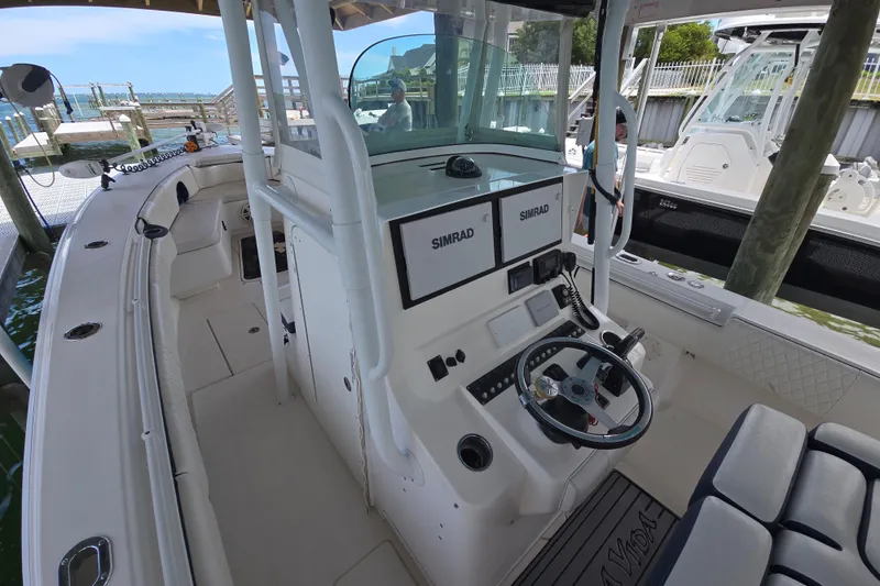 Slide: The Image of 2012 Contender 32 LS boat interior with Simrad electronics and steering wheel. - 10