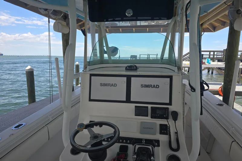 Slide: The Image of 2012 Contender 32 LS boat dashboard with Simrad displays and Garmin equipment. - 11