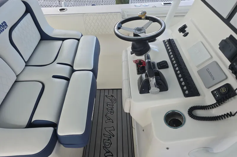 Slide: The Image of 2012 Contender 32 LS boat interior with steering wheel and seating. - 14