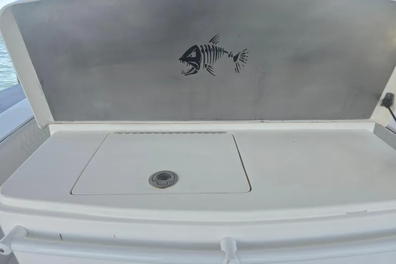 Slide: The Image of Contender 32 LS 2012 boat with fish skeleton design on storage compartment. - 16