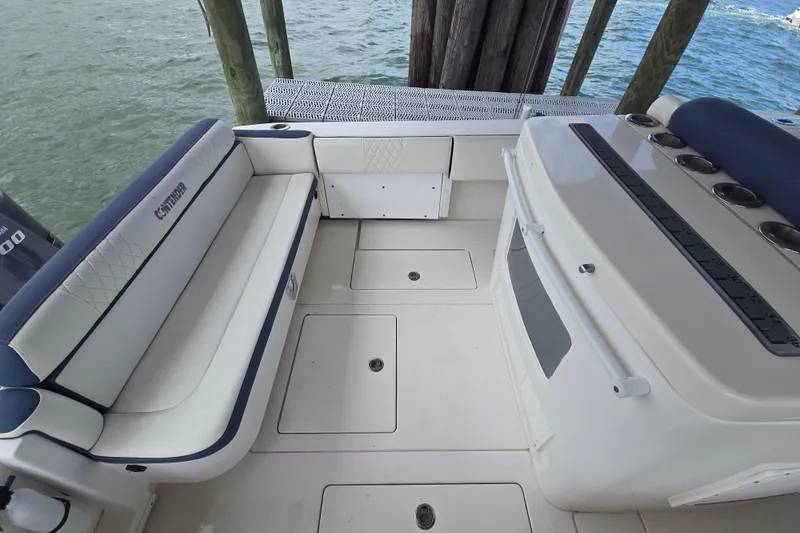 Slide: The Image of 2012 Contender 32 LS boat interior with seating and storage, docked by the water. - 20