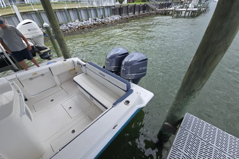 Slide: The Image of 2012 Contender 32 LS boat docked with twin Yamaha engines. - 23