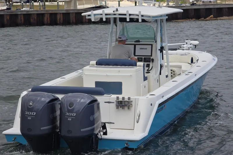 Slide: The Image of 2012 Contender 32 LS boat with dual Yamaha 300 engines on water. - 5