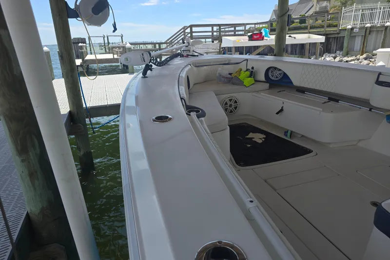 Slide: The Image of 2012 Contender 32 LS boat docked, featuring spacious seating and modern amenities. - 9