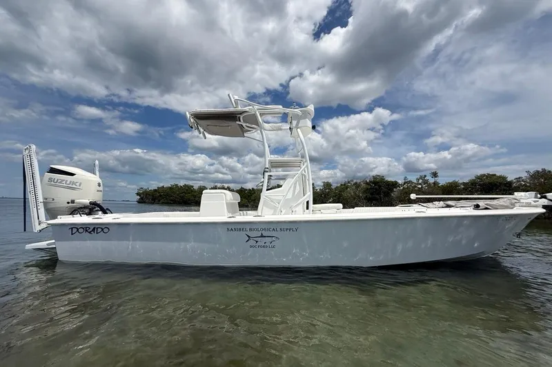 Slide: The Image of 2016 Dorado 25 SE boat with Suzuki engine on calm water under cloudy sky. - 10