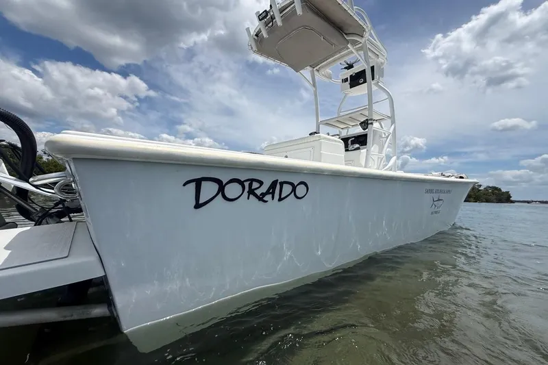 Slide: The Image of 2016 Dorado 25 SE boat on water under cloudy sky. - 11