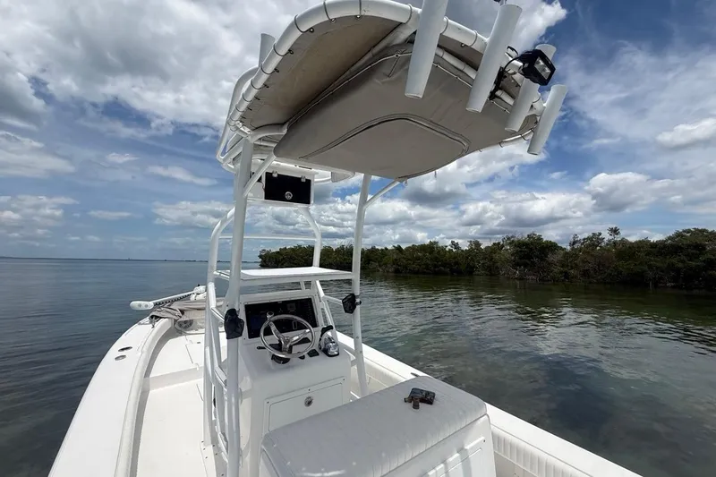 Slide: The Image of 2016 Dorado 25 SE boat on calm water under a cloudy sky. - 12