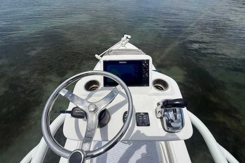 Slide: The Image of Steering console of 2016 Dorado 25 SE boat with navigation equipment. - 13